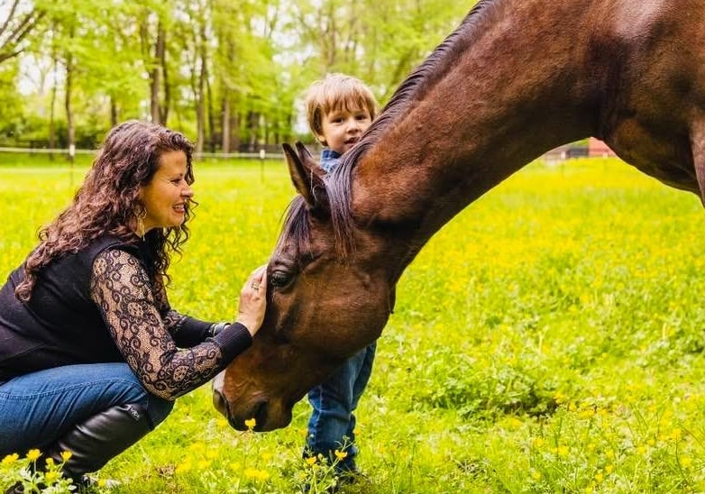 Family and therapist sharing a quiet moment with a horse