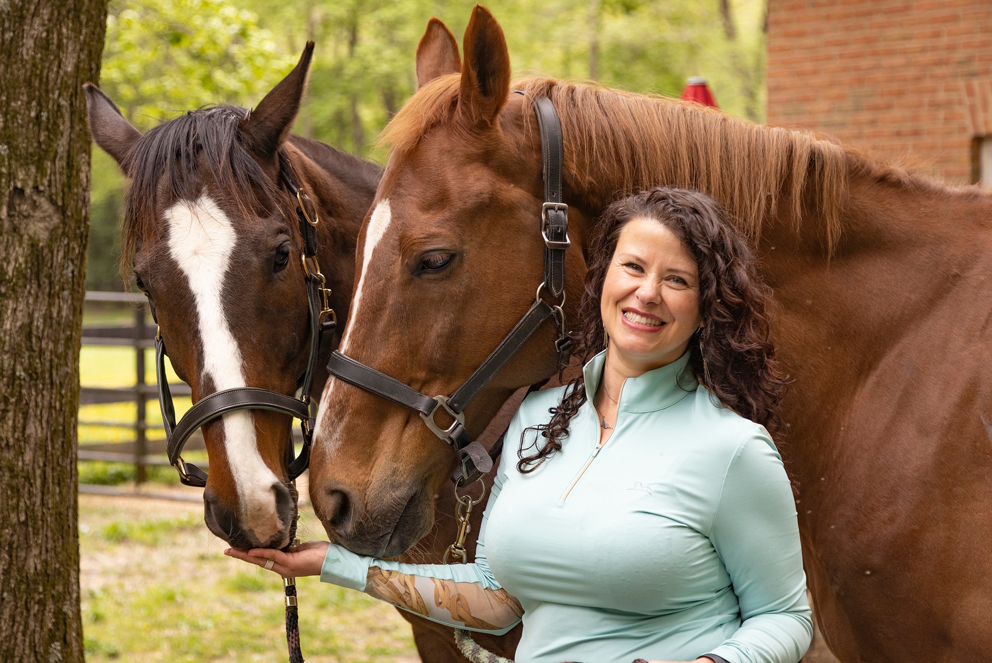 Dr. Ioana Marcus with two horses outdoors